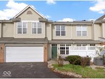 Charming townhouse boasts an attached garage and inviting front patio, perfect for outdoor relaxation at 2231 Colfax Ln, Indianapolis, IN 46260