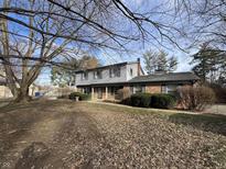 Charming two-story home with a brick facade and well-maintained front yard in a quiet neighborhood at 2559 Pleasant W Way, Carmel, IN 46280