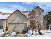 Tan two-story house with snow covered yard and attached garage at 397 Polk Village Rd, Greenwood, IN 46143