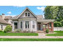 Charming two-story home with a covered porch and well-manicured landscaping at 460 W Morgan St, Martinsville, IN 46151