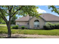 Charming brick home featuring a well-maintained lawn and mature trees, creating a welcoming curb appeal at 5850 Bradston Way, Indianapolis, IN 46237