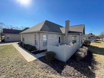 Back exterior view of home featuring brick, chimney, fence and landscaped yard at 5850 Bradston Way, Indianapolis, IN 46237