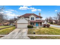 Charming two-story home features a covered porch, attached garage, and well-manicured lawn at 6530 Duck Pond Dr, Fishers, IN 46038