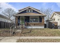 Brick home with blue siding and a green door at 940 N Chester Ave, Indianapolis, IN 46201