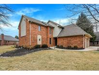 Charming brick home featuring manicured landscaping and attached two-car garage at 10 Wildwood Ct, Brownsburg, IN 46112