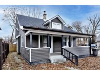 Gray house with white trim, front porch, and landscaping at 1058 N Holmes Ave, Indianapolis, IN 46222