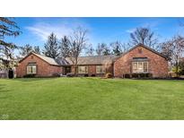 Charming brick home featuring a well-manicured front lawn and mature trees, perfect for curb appeal at 1175 Princeton Pl, Zionsville, IN 46077