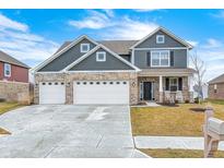 Charming two-story home featuring a brick facade and a three-car garage with blue skies above at 33 N Highland Knoll Way, Bargersville, IN 46106