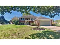 Charming brick home with two-car garage and mature trees, offering a welcoming curb appeal at 566 Lacy Cir, Greenwood, IN 46142