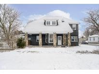 Charming home exterior featuring stone pillar accents on a snow-covered lot at 602 N Harrison St, Alexandria, IN 46001