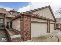 Brick front exterior with a two-car attached garage and American flag at 633 Cielo Vista Dr, Greenwood, IN 46143