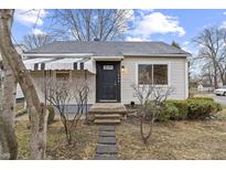 Inviting single-story home with a classic black front door and landscaped yard at 633 S Grand Ave, Indianapolis, IN 46219