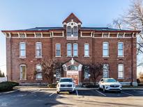 Classic brick building featuring symmetrical facade, ample parking, and distinctive architectural details at 714 Buchanan St # 17, Indianapolis, IN 46203