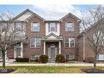 Charming brick townhome with well-maintained landscaping and a welcoming entrance at 8434 Clayhurst Dr, Indianapolis, IN 46278