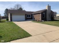 Charming single-story home with a brick facade, attached garage, and a well-manicured lawn at 971 Alexander St, Greenwood, IN 46143