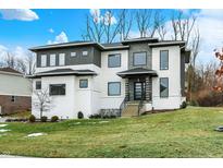 Stunning two-story home with modern architecture, stone accents, and manicured lawn at 10519 Geist View Dr, Fishers, IN 46055