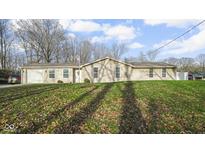Single story home with neutral siding, an attached garage, and well maintained lawn at 1090 Robb Hill Rd, Martinsville, IN 46151