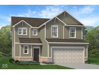 Charming two-story home with an attached two-car garage, brick accents, green siding and a well-manicured lawn with landscaping at 1934 Black Oak Dr, Shelbyville, IN 46176