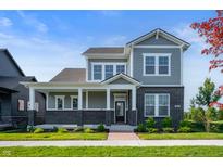 Charming two-story home with gray siding, brick accents, and a welcoming front porch at 19997 Old Dock Rd, Westfield, IN 46074