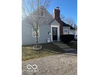Charming, freshly painted two-story home with a well-kept lawn and welcoming front door at 4025 E 36Th St, Indianapolis, IN 46218