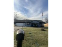 Charming single-story home with attached garage and well-maintained front yard under a partly cloudy sky at 4916 Ingleside Ln, Indianapolis, IN 46227