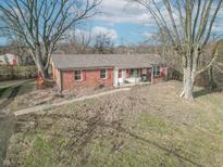 Charming brick home with red shutters and mature trees on a spacious lawn at 6170 S County Road 675 E Rd, Plainfield, IN 46168