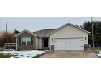 Charming single-story home featuring a two-car garage, brick accents, and welcoming front entrance at 1201 Brooke Dr, Lebanon, IN 46052