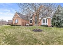 Charming two-story brick home with manicured front lawn and mature landscaping, offering classic curb appeal at 13265 Talon Crest Dr, Fishers, IN 46037