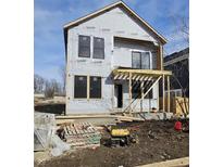 Exterior of a home under construction with visible Typar paper, black windows, and a wooden porch framework at 1523 N Beville Ave, Indianapolis, IN 46201