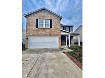 Two-story brick home with white trim, a two-car garage, and a covered porch at 1708 Sonesta Way, Indianapolis, IN 46217
