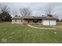 Charming single-story home with a well-maintained lawn, solar panels, and an attached two-car garage at 22474 Craig Ave, Noblesville, IN 46060