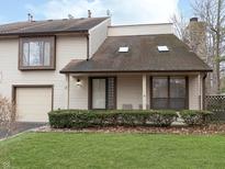 Charming two-story home with a well-manicured front yard and a cozy, covered front porch at 2563 Hideaway S Dr, Indianapolis, IN 46268