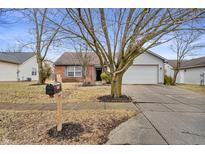 Charming single-Gathering home with a well-maintained front yard and attached two-car garage at 3833 Libra Ln, Indianapolis, IN 46235