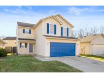 Two-story home featuring blue shutters and a matching two-car garage door at 411 Red Tail Ln, Indianapolis, IN 46241