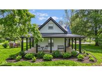 Inviting covered front porch with black accents, perfect for relaxing outdoors at 4131 N County Road 500 E, Danville, IN 46122