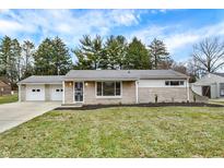 Charming single-story home with stone and vinyl siding, plus an attached two-car garage at 4909 Ingleside Ln, Indianapolis, IN 46227