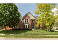 Charming two-story brick home with a well-manicured lawn and mature trees at 5208 Clear Lake Ct, Carmel, IN 46033