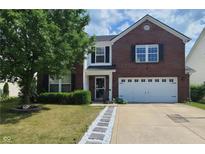 Charming brick two-story home with a well-manicured lawn, white garage door, and lovely walkway at 5731 W Woodview Trl, McCordsville, IN 46055