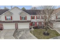Aerial view of a two-story townhouse with red shutters and a driveway at 6275 Eller Creek Way, Fishers, IN 46038
