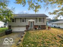 Charming home with mature trees and a well-maintained front yard at 727 Sunset Blvd, Greenwood, IN 46142
