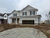 Charming two-story home with gray siding, brick accents, and a spacious two-car garage at 840 Arkansas Ct, Westfield, IN 46074