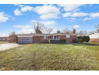 Charming single-story brick home featuring a well-maintained front lawn and attached garage at 8543 W 10Th St, Indianapolis, IN 46234