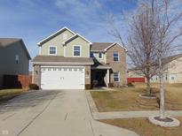 Charming two-story home features a two-car garage, brick and vinyl siding, and a well-manicured front lawn at 978 Brookshire Dr, Franklin, IN 46131