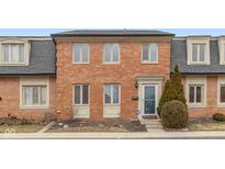 Charming brick townhouse featuring multiple windows and a well-maintained front yard at 1156 Canterbury N Sq, Indianapolis, IN 46260