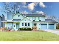 Charming two-story home with attached two-car garage and beautifully maintained lawn at 11710 E 75Th St, Indianapolis, IN 46236