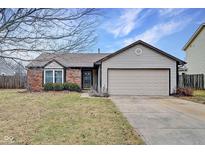 Charming single-story home featuring brick and siding, attached two-car garage, and a well-maintained front yard at 1408 Thomas Dr, Lebanon, IN 46052