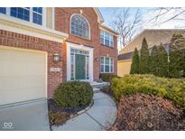 Inviting front entrance with a well-maintained garden and a walkway leading to the front door at 4643 Big Run Ct, Indianapolis, IN 46239
