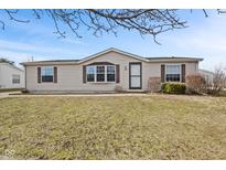 Charming single-story home with neutral siding, complemented by mature landscaping at 4676 Autumn Ridge Dr, Columbus, IN 47203