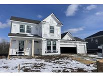 Two-story home showing construction details with a three car garage and covered porch at 567 Hidden Hills Dr, Pittsboro, IN 46167