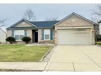 Charming brick home with blue shutters, well-manicured lawn, and a two-car garage at 6405 Oyster Key Ln, Plainfield, IN 46168
